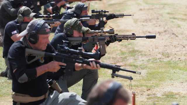 Competitors on the firing line at a CSR match, service rifles up