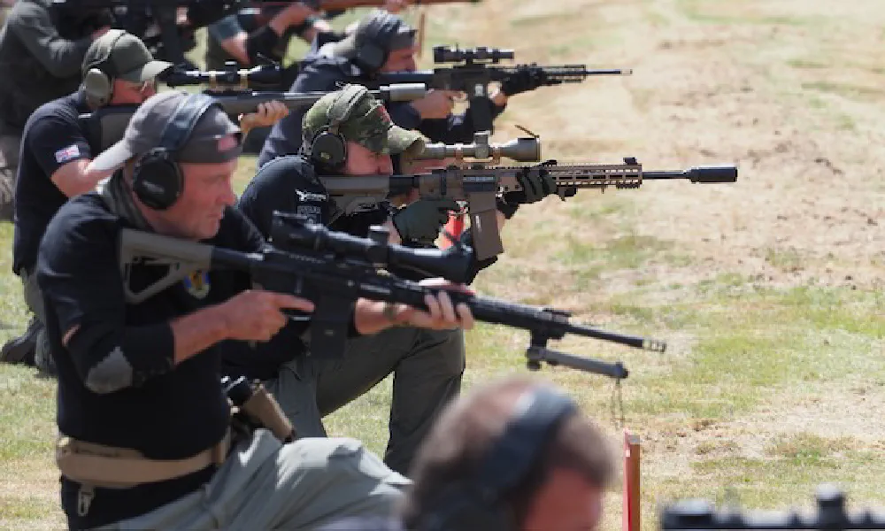 A straight-pull service rifle on the firing point at Bisley, the numbered target butts and range flag behind