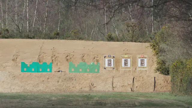 Targets on the butts at Short Siberia, Bisley: Figure 12 targets and green urban silhouettes against the sand berm